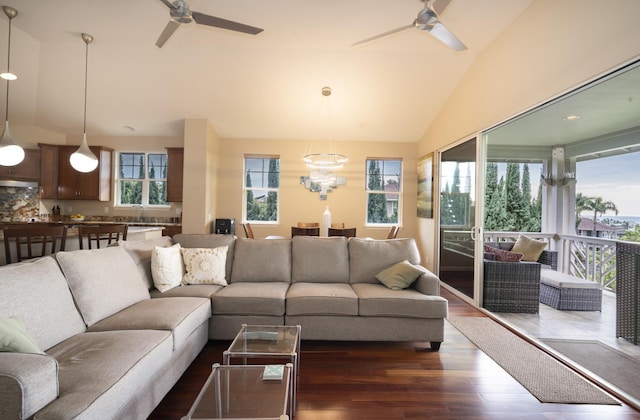 living room with dark wood-style floors, vaulted ceiling, and ceiling fan