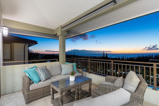 patio terrace at dusk featuring a balcony