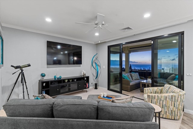 living room featuring ceiling fan and ornamental molding