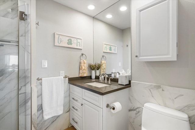 bathroom featuring an enclosed shower, vanity, toilet, and tile walls