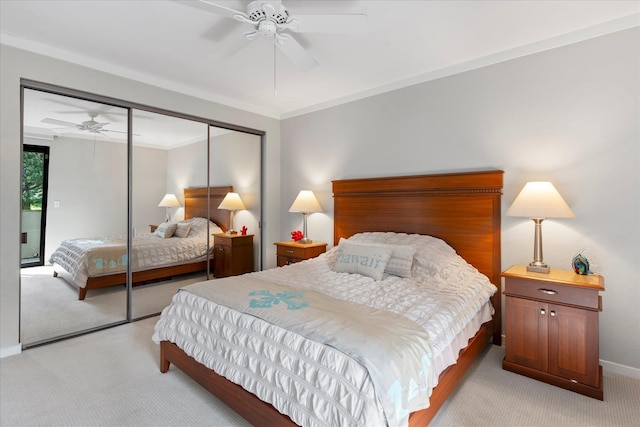 carpeted bedroom featuring ceiling fan, ornamental molding, and a closet