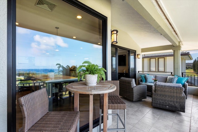 exterior space with a balcony and an outdoor hangout area