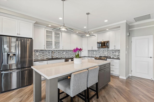 kitchen with white cabinetry, sink, and appliances with stainless steel finishes