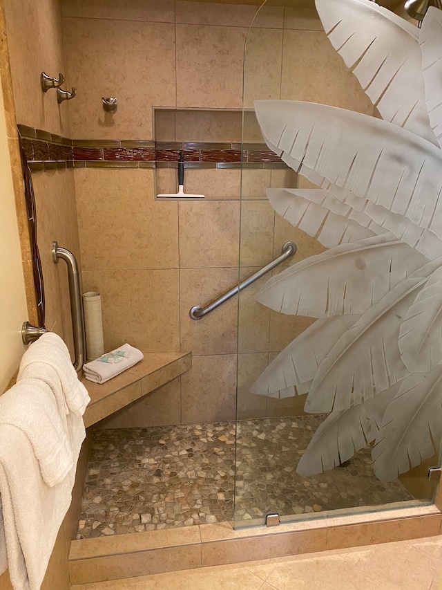 bathroom with a tile shower