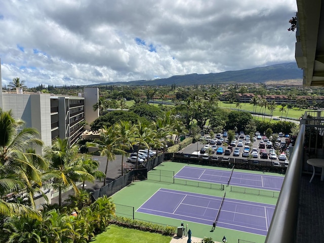 view of tennis court with a mountain view