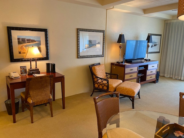 carpeted living room with beam ceiling