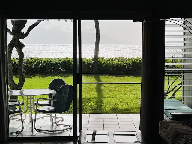 doorway featuring a water view and tile patterned flooring