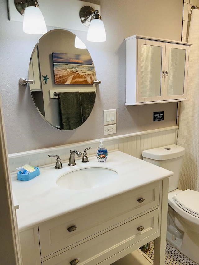 bathroom featuring toilet and vanity