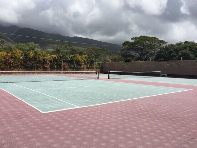 view of tennis court with a mountain view