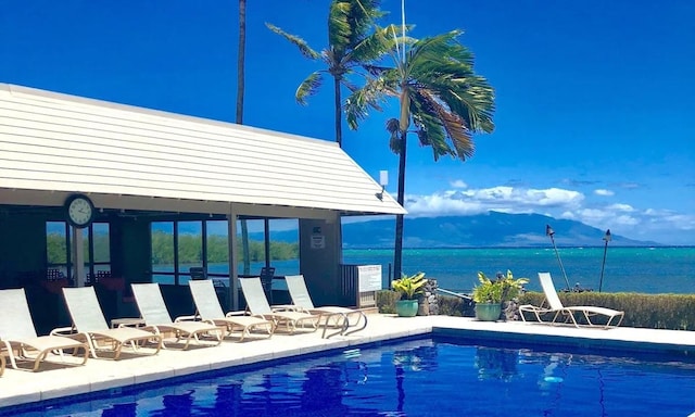 view of swimming pool featuring a water view