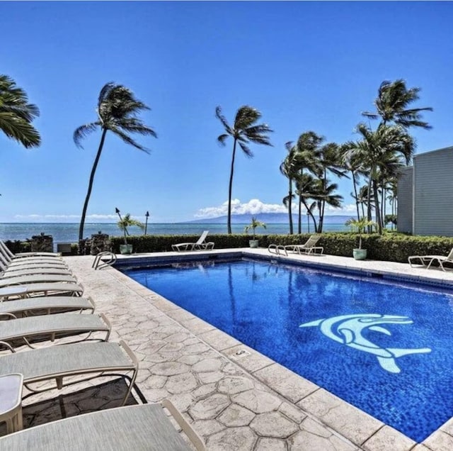 view of pool with a water view