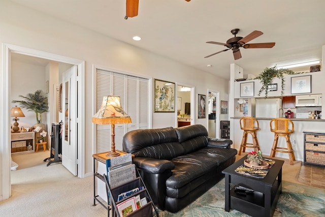 carpeted living room featuring ceiling fan