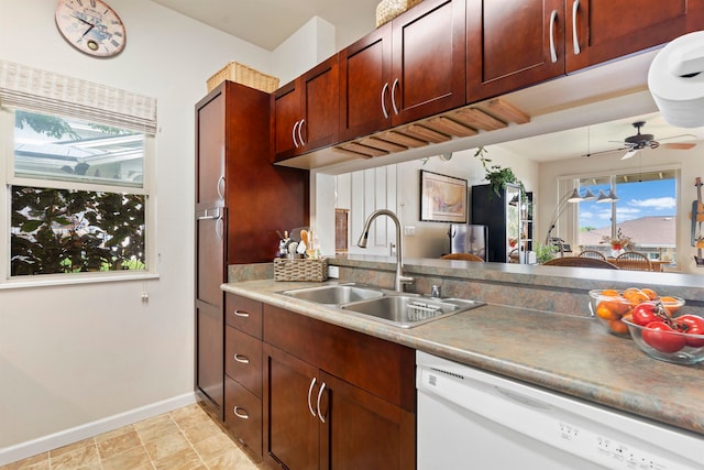 kitchen with ceiling fan, white dishwasher, and sink