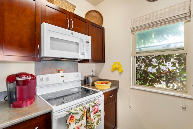 kitchen with tasteful backsplash and white appliances