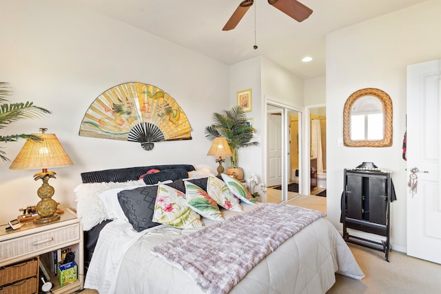 carpeted bedroom featuring ceiling fan and ensuite bathroom