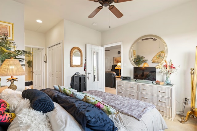 bedroom with ceiling fan and light carpet