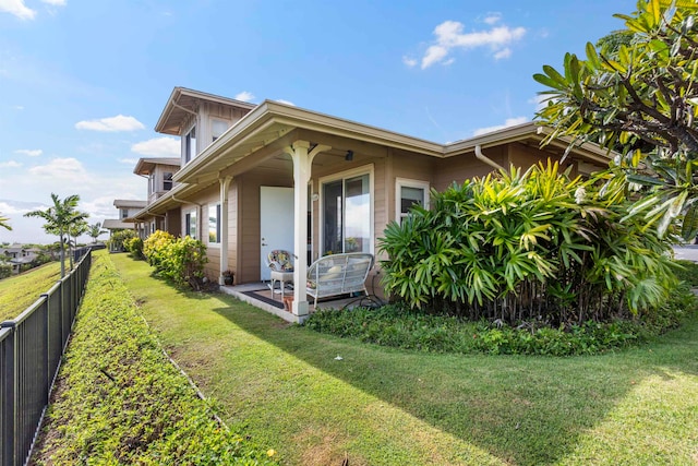 view of side of home featuring a lawn