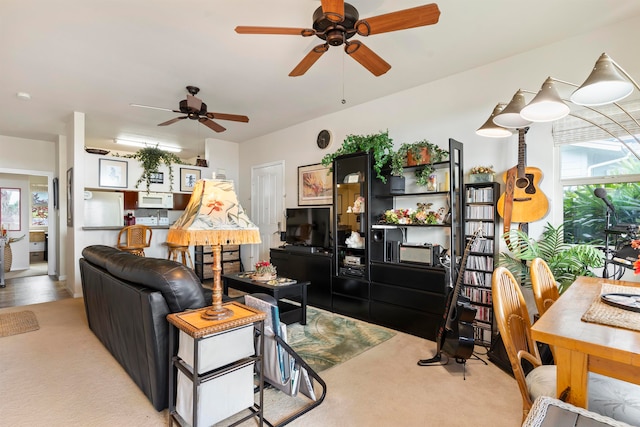 carpeted living room with a healthy amount of sunlight and ceiling fan