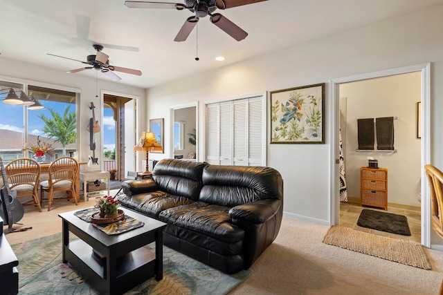 living room featuring light carpet, a healthy amount of sunlight, and ceiling fan