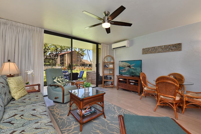 living room with a wall of windows, ceiling fan, hardwood / wood-style flooring, and an AC wall unit