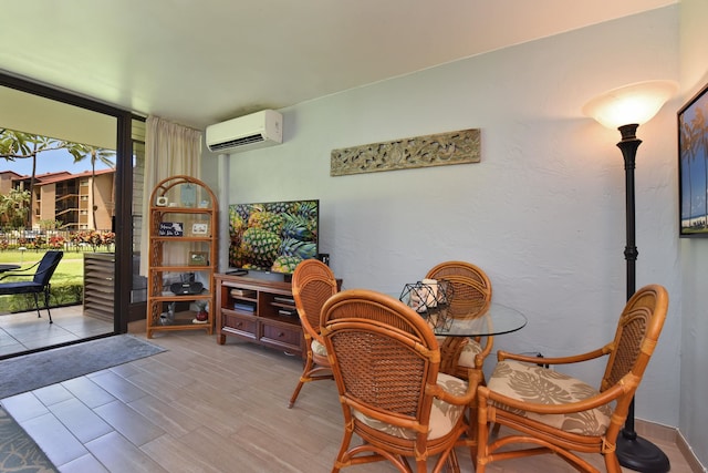 dining area featuring light hardwood / wood-style floors, floor to ceiling windows, and a wall mounted AC