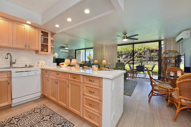 kitchen featuring sink, white dishwasher, tasteful backsplash, ceiling fan, and kitchen peninsula