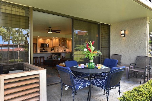 view of patio / terrace featuring sink and ceiling fan