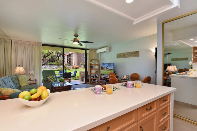 kitchen featuring a tray ceiling, ceiling fan, and a wall mounted air conditioner