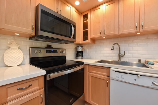 kitchen featuring sink, tasteful backsplash, light brown cabinetry, and stainless steel appliances