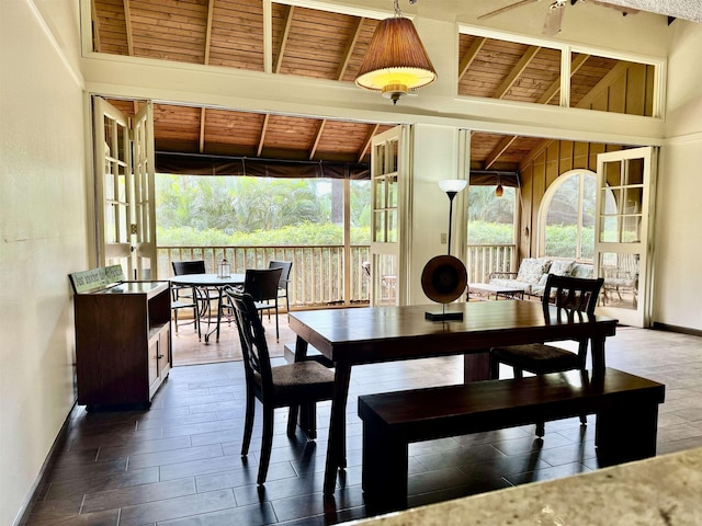 dining area featuring wood ceiling, plenty of natural light, and lofted ceiling with beams