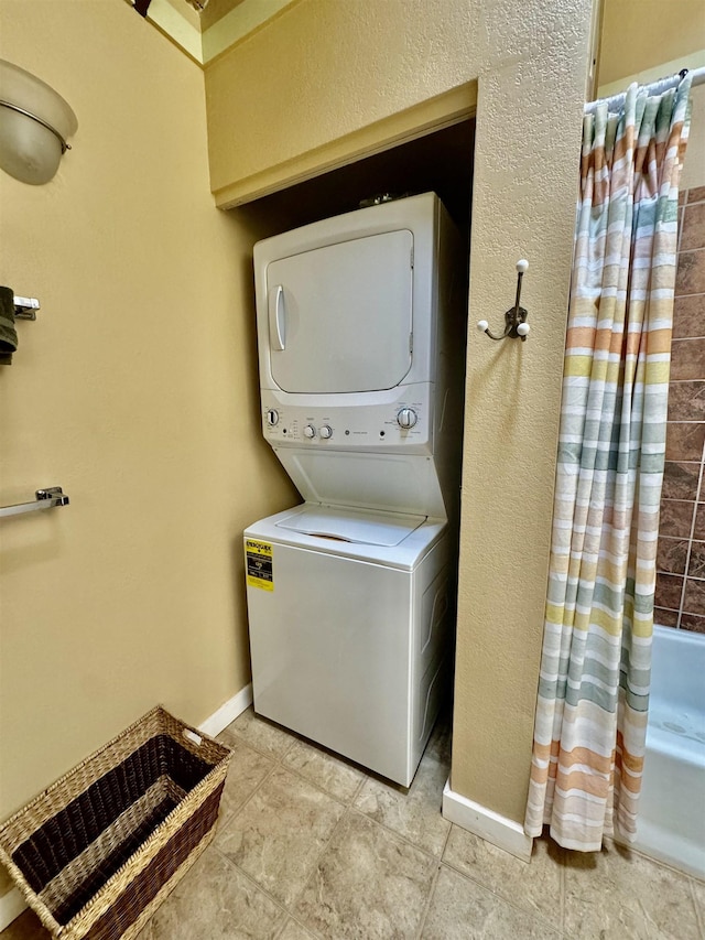 washroom featuring stacked washer and clothes dryer