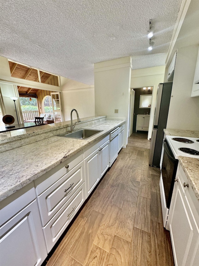 kitchen featuring range with electric cooktop, white cabinetry, white dishwasher, and sink