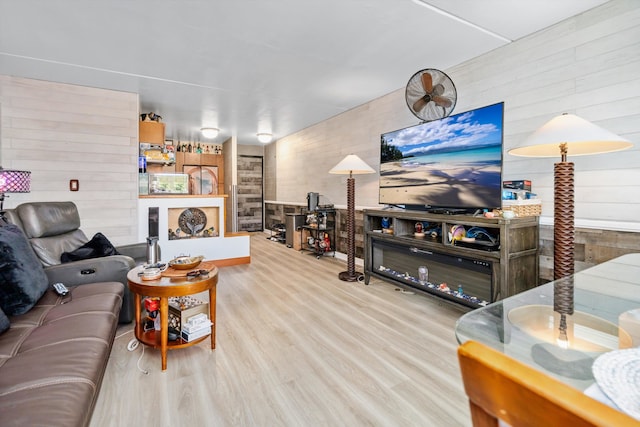 living area with wood walls and wood finished floors