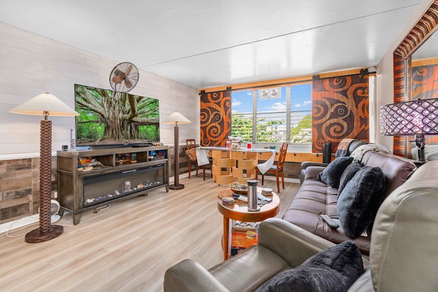 living room with wood walls and wood finished floors