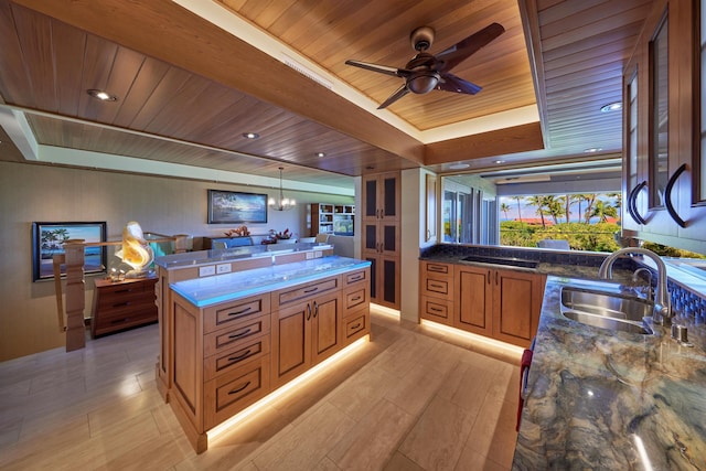 4000 Wailea Alanui Dr Unit 901, Kihei, HI 96753 - kitchen with wood ceiling, brown cabinetry, dark stone counters, ceiling fan, and a raised ceiling