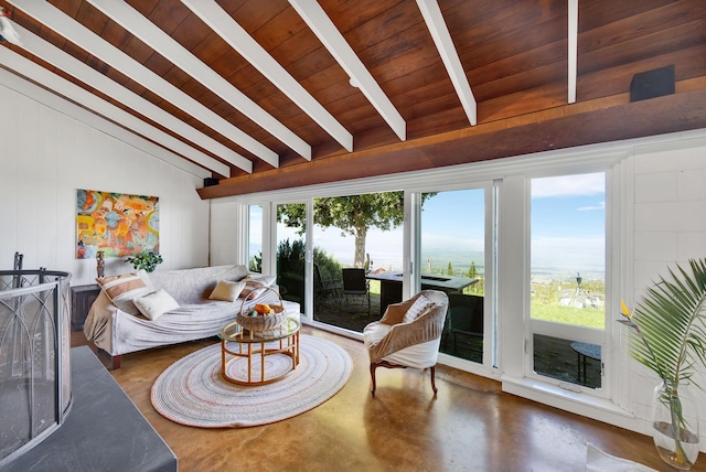 living room featuring finished concrete flooring, plenty of natural light, lofted ceiling with beams, and wood ceiling