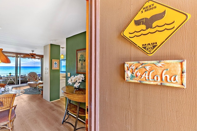 interior space featuring a water view, hardwood / wood-style flooring, and ceiling fan