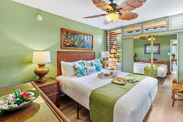 bedroom featuring ceiling fan, light wood-type flooring, and a closet