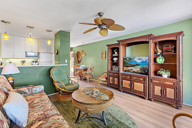 living room with light wood-type flooring and ceiling fan