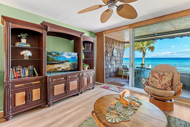 living room with ceiling fan and light hardwood / wood-style floors