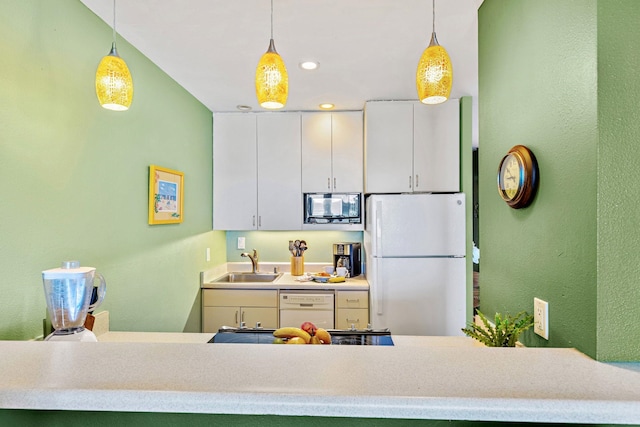 kitchen with white cabinets, decorative light fixtures, and white appliances