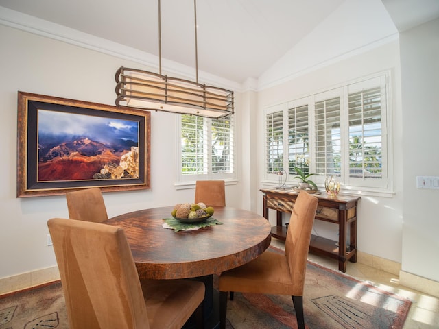 tiled dining area featuring plenty of natural light and lofted ceiling