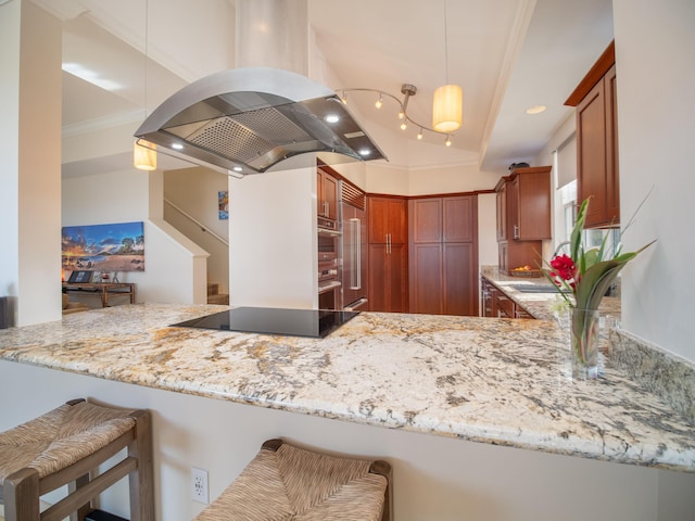 kitchen featuring kitchen peninsula, island range hood, black electric cooktop, and pendant lighting