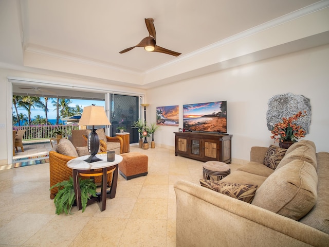 living room with ceiling fan, a raised ceiling, and crown molding