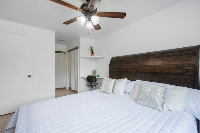 bedroom with ceiling fan and light tile patterned floors