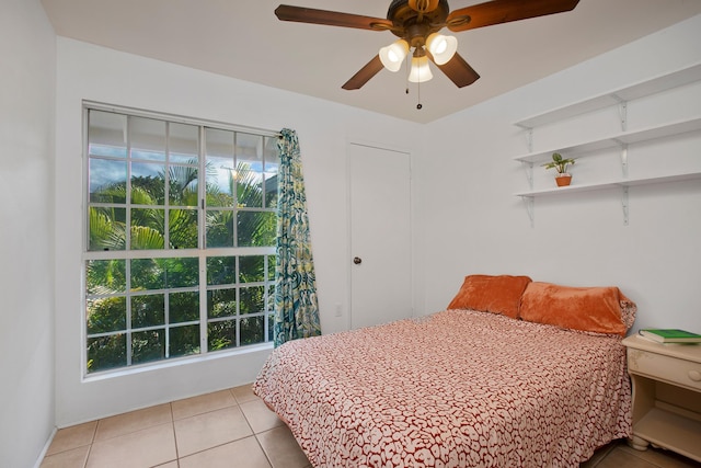 tiled bedroom with ceiling fan