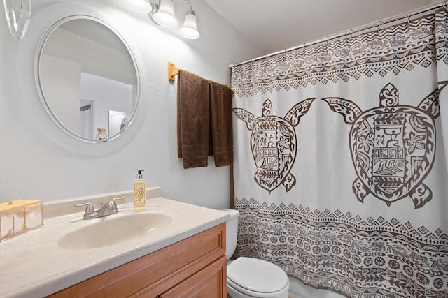 bathroom with vanity, toilet, and walk in shower