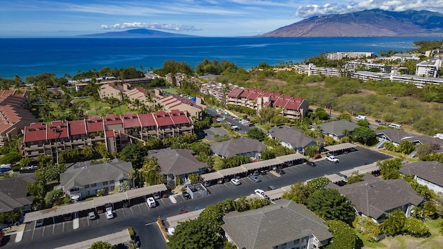 birds eye view of property with a water and mountain view