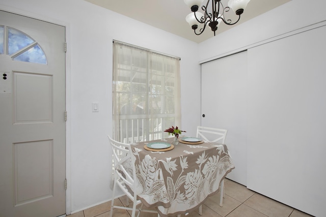 dining area featuring an inviting chandelier and light tile patterned flooring