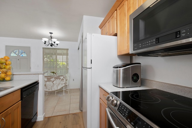 kitchen with a notable chandelier, light wood-type flooring, stainless steel appliances, and decorative light fixtures